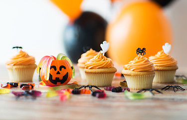 Image showing halloween party decorated cupcakes on wooden table