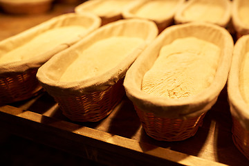 Image showing yeast bread dough in baskets at bakery kitchen