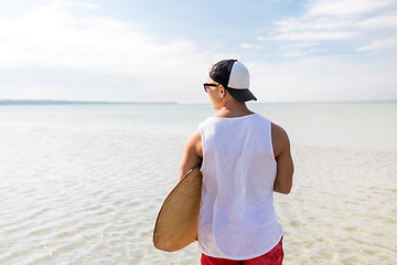 Image showing happy young man with skimboard on summer beach