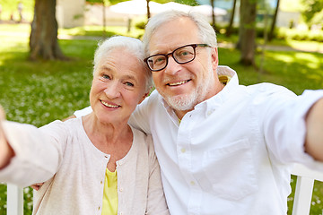 Image showing senior couple taking selfie at summer park 