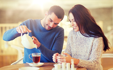 Image showing happy couple drinking tea at cafe