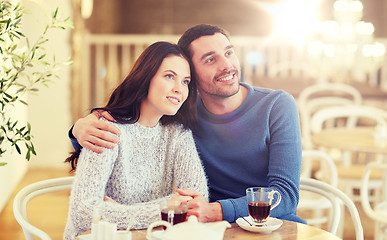 Image showing happy couple drinking tea at restaurant