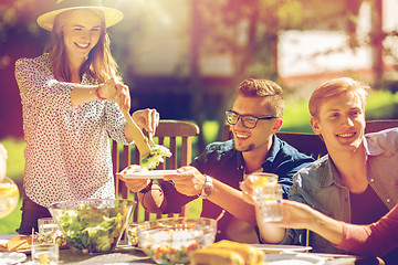 Image showing happy friends having dinner at summer garden party