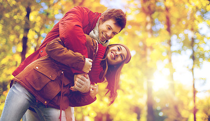 Image showing happy young couple having fun in autumn park