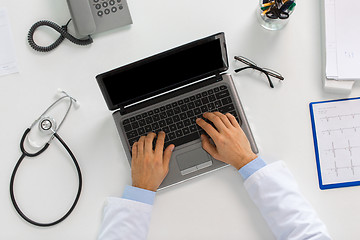 Image showing doctor hands typing on laptop at clinic