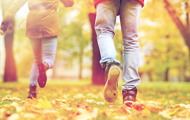 Image showing young couple running in autumn park