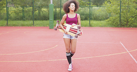 Image showing Sportive woman with longboard