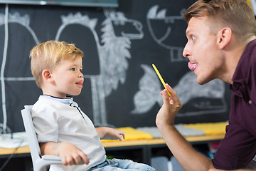 Image showing Cute little boy at speechtherapist session.