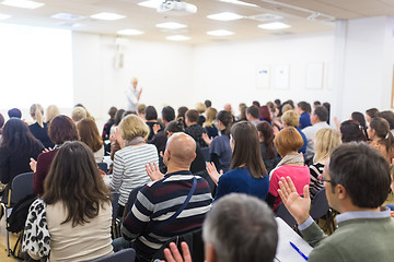 Image showing Woman giving interactive motivational speech at entrepreneurship workshop.