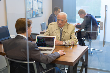 Image showing Financial advisor consulting senior client with his investment strategy.