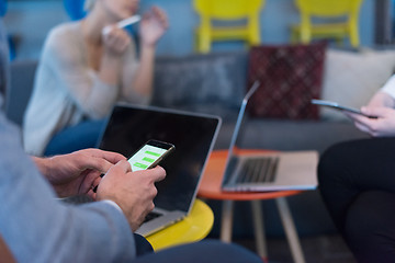 Image showing Young casual businessman using smartphone