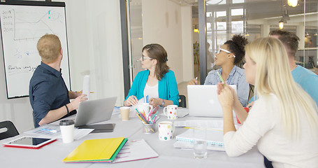 Image showing Young coworkers exploring graphic in office