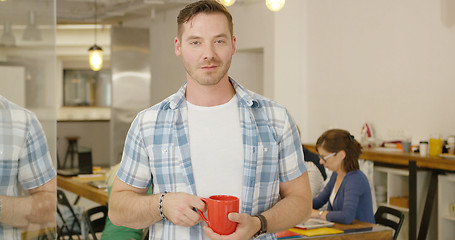 Image showing Man with coffee in office