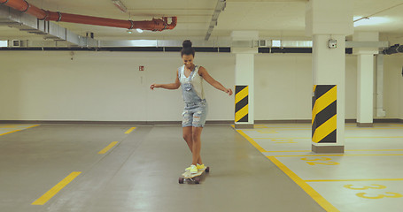 Image showing Girl skateboarding on parking