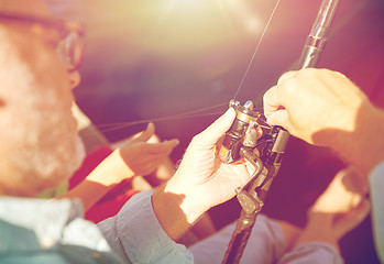 Image showing senior man with fishing rod or spinning on river