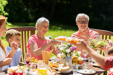 Image showing happy family having dinner or summer garden party