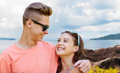 Image showing happy teenage couple hugging outdoors