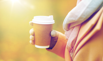 Image showing close up of woman with coffee in autumn park