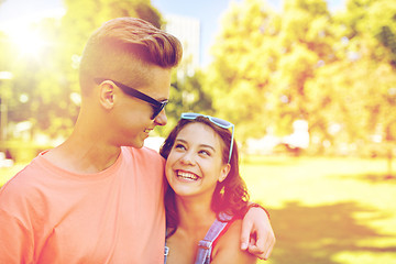 Image showing happy teenage couple looking at each other in park