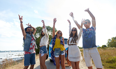 Image showing smiling hippie friends having fun near minivan car