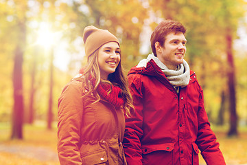 Image showing happy young couple walking in autumn park