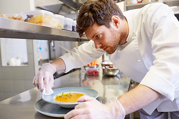 Image showing male chef cooking food at restaurant kitchen