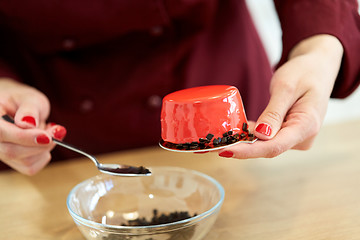 Image showing chef decorating mirror glaze cakes at pastry shop