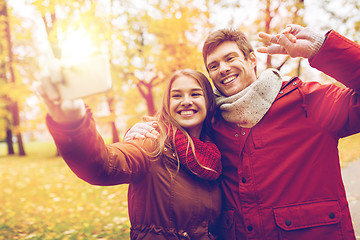 Image showing couple taking selfie by smartphone in autumn park