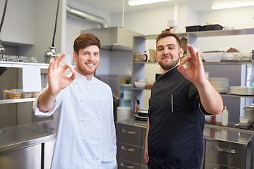 Image showing happy chefs at restaurant kitchen showing ok sign