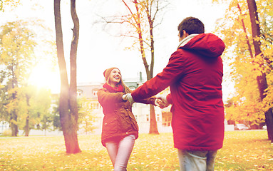 Image showing happy young couple having fun in autumn park