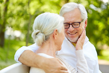 Image showing happy senior couple hugging in city park