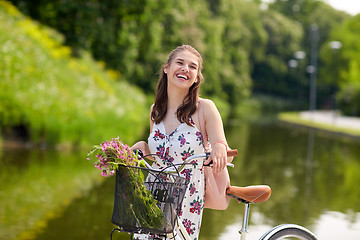 Image showing happy woman riding fixie bicycle in summer park