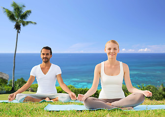 Image showing couple doing yoga in lotus pose outdoors