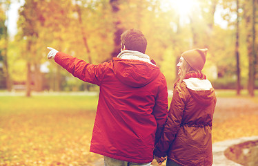 Image showing happy young couple walking in autumn park