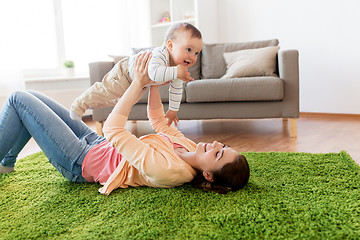 Image showing happy young mother playing with baby at home