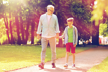 Image showing grandfather and grandson walking at summer park
