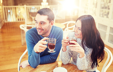 Image showing happy couple drinking tea at cafe
