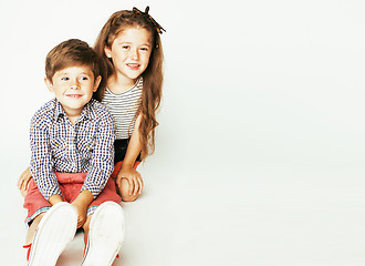 Image showing little cute boy and girl hugging playing on white background, ha