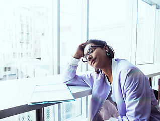 Image showing young cute hipster girl student sitting in cafe with notebook re