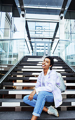 Image showing young cute indian girl at university building sitting on stairs 