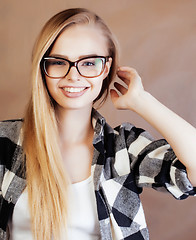 Image showing young pretty blond woman with smartphone posing smiling, making 