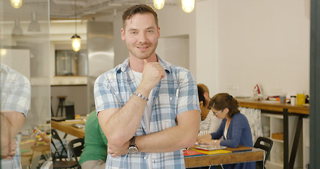 Image showing Smiling male employee posing