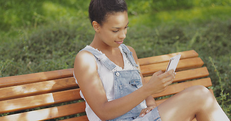 Image showing Model taking selfie on bench