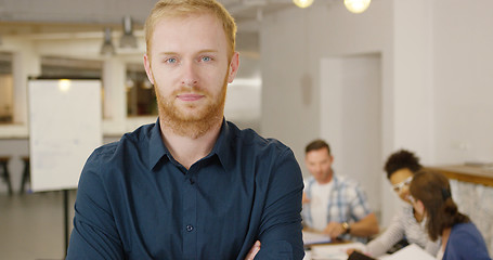 Image showing Man posing in office with coworkers