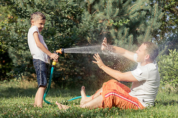 Image showing Happy father and son playing in the garden at the day time.