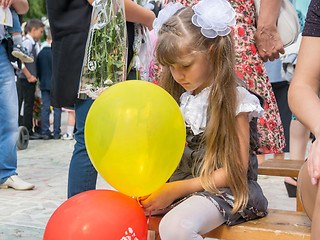 Image showing Sad girl sitting with balls in hands on September 1 holiday