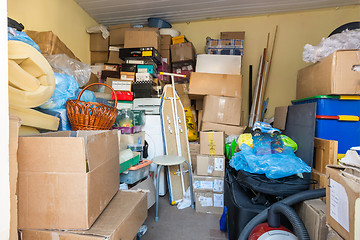 Image showing Moving, things packed in boxes and packages lie in a small room