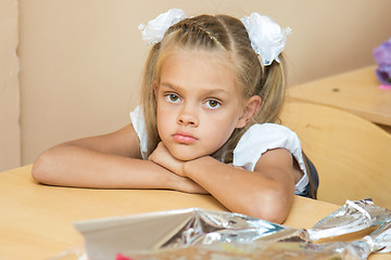 Image showing A sad girl at her desk at the lesson of the first of September