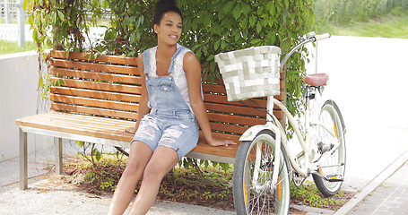 Image showing Woman relaxing on bench