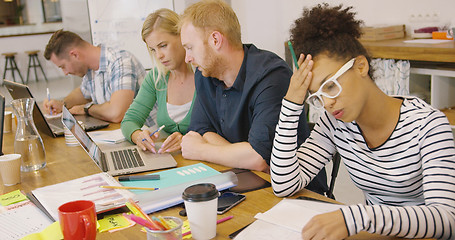 Image showing Young people working hard in office